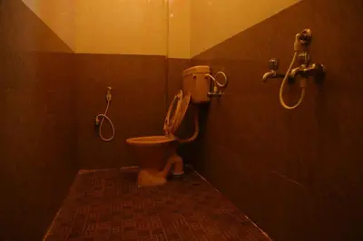 a bathroom with a toilet and a shower at PRANOV RESIDENCY-Luxury in Coimbatore