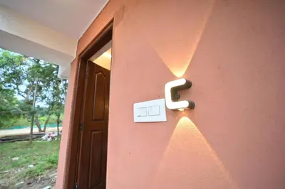 a door with a lightswitch on the side of a house at Coorg HomeStay Resort in Kushālnagar