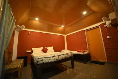 a room with two beds in a red brick wall at Coorg HomeStay Resort in Kushālnagar