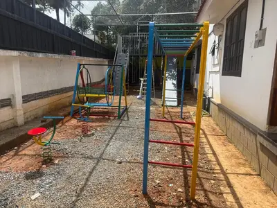a group of playground equipment sitting next to a building at Empire Pool Villa in Meenangadi