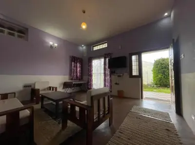 a living room with a table and a dining room at Misty Moonrise in Kūkkāl