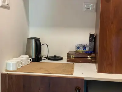 a kitchen counter with a coffee maker and cups on it at Coffee Cradle Wayanad Luxuorios Private Tree House - Inside 2 Acre Coffee Plantation in Mananthavady