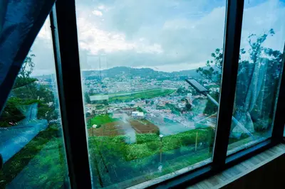 a view of a city from a window at Tulips Resorts - Elkhill in Ooty