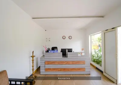 an office with a reception desk in a room at Munnar Majestic Resort with Pool in Munnar