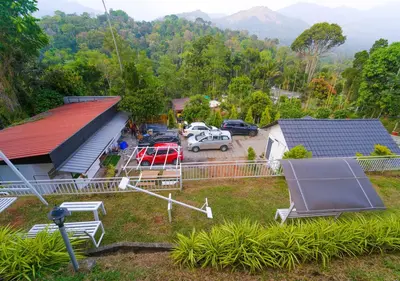 an aerial view of a house with a parking lot at Munnar Majestic Resort with Pool in Munnar