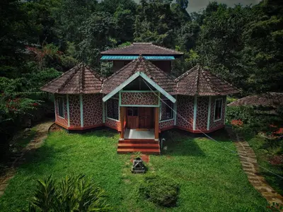 an aerial view of a house in the grass at Mahout Resort Wayanad - An Experiential Jungle Stay with Waterfall in Kalpetta