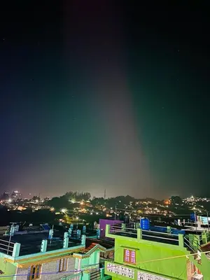a view of a city at night with buildings at Golden View Cottage Ooty in Ooty