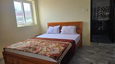 a bedroom with a bed with a blanket on it at Golden View Cottage Ooty in Ooty