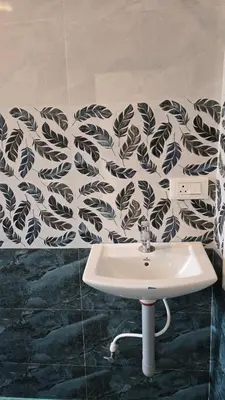 a bathroom with a sink and a black and white wallpaper at Golden View Cottage Ooty in Ooty