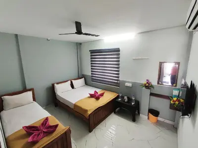 a bedroom with two beds and a table with bows at Sri Aksha Residency in Alāndurai