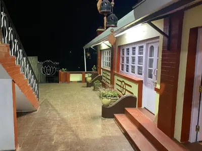a porch of a house at night with a plant at Kanjira house in Ooty