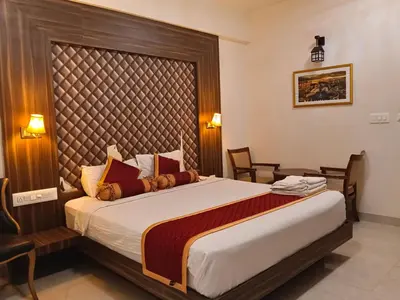 a bedroom with a large bed in a room at Grand Milestone in Mysore