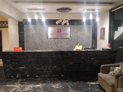 a bar in a lobby with a sign on a wall at Grand Milestone in Mysore