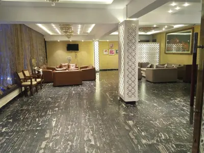 a lobby with couches and couches in a room at Grand Milestone in Mysore