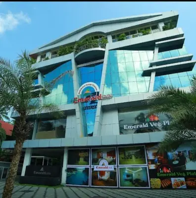 a building with a sign on the side of it at Nakshatra Emerald in Guruvāyūr