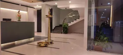 a museum with a gold pole in the middle of a room at Nakshatra Emerald in Guruvāyūr