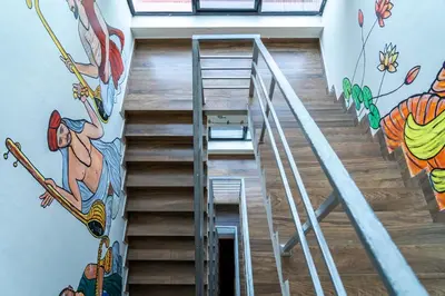 a staircase with a mural of a man on a skateboard at DREAMS AIRPORT RESIDENCY in Nedumbassery