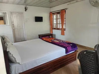 a small bed in a room with a window at COTTAGE GARDEN DEEPIKAS in Parambikolam