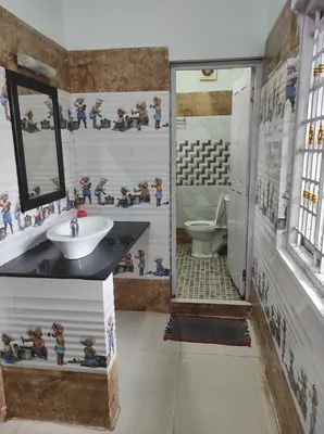 a bathroom with a sink and a toilet at COTTAGE GARDEN DEEPIKAS in Parambikolam