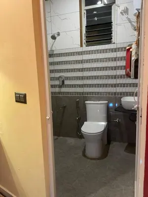 a bathroom with a toilet and a sink at Four Seasons Homestay single room in Madikeri