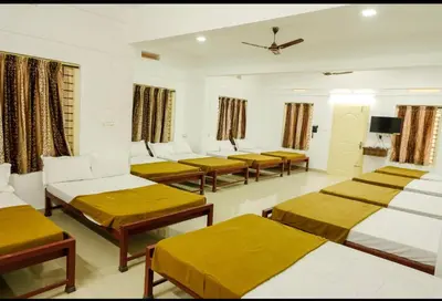 a room with a bunch of beds in it at sevens residency in Sultan Bathery