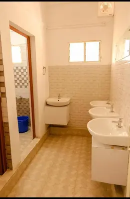 a bathroom with three sinks and three sinksktop at sevens residency in Sultan Bathery