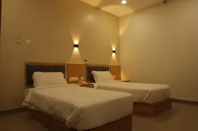 a hotel room with two beds and two lights at Dreamotel Luxury Suites in Kanjikode