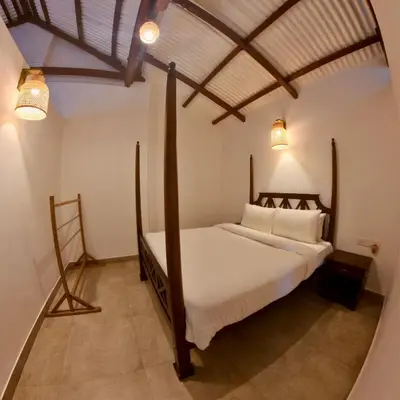 a bedroom with a large bed in a room at Welbeck Vintage By Oxygen Resorts in Ooty