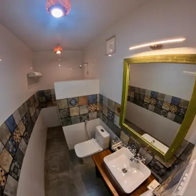 a bathroom with a sink and a mirror at Welbeck Vintage By Oxygen Resorts in Ooty