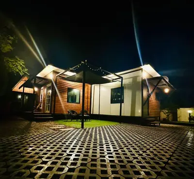 a house at night with a cobblestone street at WHOOSH HOMES in Cochin