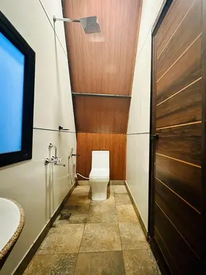 a bathroom with a toilet and a sink at WHOOSH HOMES in Cochin