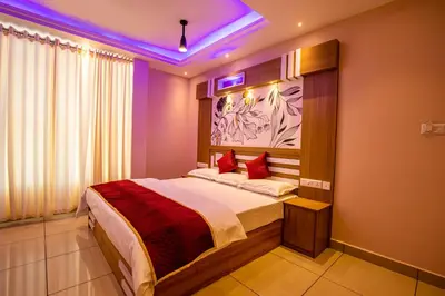 a bedroom with a large bed with a purple ceiling at IvyArk Residency in Pinangode