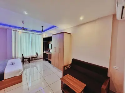 a living room with a couch and a table at IvyArk Residency in Pinangode