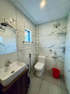 a bathroom with a sink and a toilet at IvyArk Residency in Pinangode