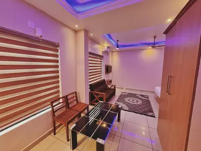a small room with a table and chairs in a room at IvyArk Residency in Pinangode