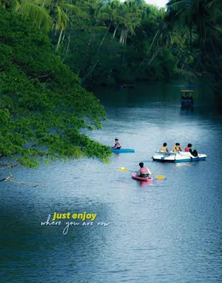 a group of people in kayaks on a river at Furnished 2 BHK Family Apartments near Triprayar Shree Rama Temple - Beevees Homes Thriprayar in Thanniyam
