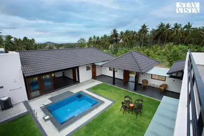 an aerial view of a house with a swimming pool at StayVista at Ava - The Country House with Breakfast & Miniature Golf in Mysore