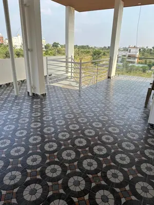 a room with a tiled floor with a view at DEEYA Home Stay - A Luxury Family Guest House in Mysore