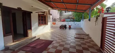 a hallway of a house with two motorcycles parked in it at SHI's Alaya 3BHk Villa in Coimbatore, near Railway station in Pīlamedu