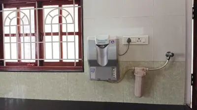 a dispenser on the wall of a public bathroom at SHI's Alaya 3BHk Villa in Coimbatore, near Railway station in Pīlamedu