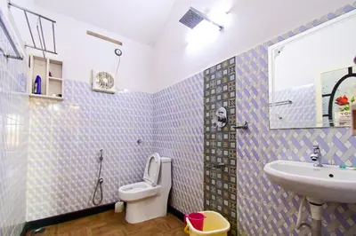 a bathroom with a toilet and a sink at S VILLA in Wayanad