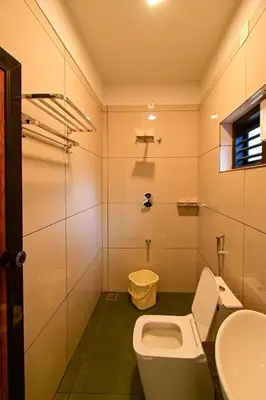 a bathroom with a toilet and a sink at S VILLA in Wayanad