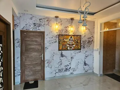a hallway with a door and a wall at Yogis Inn in Kozhikode