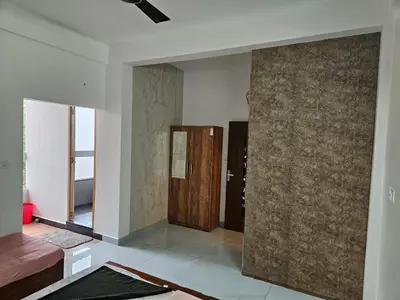 a room with a wall with a door in it at Yogis Inn in Kozhikode