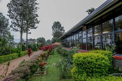 a garden in front of a building at Shola Gardens , Kotagiri in Kotagiri