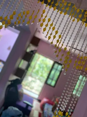 a bunch of yellow beads hanging from a lego ceiling at Lovely Private Queen Bed Room in Shared 2 BHK Apartment in Mysore