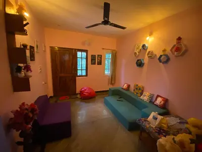 a living room with a blue couch and a ceiling at Lovely Private Queen Bed Room in Shared 2 BHK Apartment in Mysore