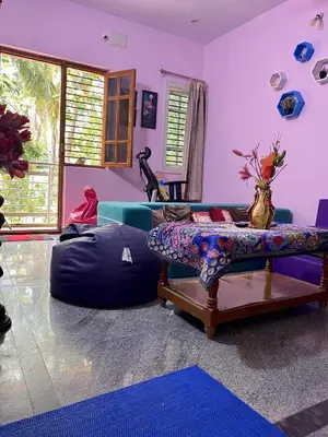 a living room with a bean bag chair and a couch at Lovely Private Queen Bed Room in Shared 2 BHK Apartment in Mysore