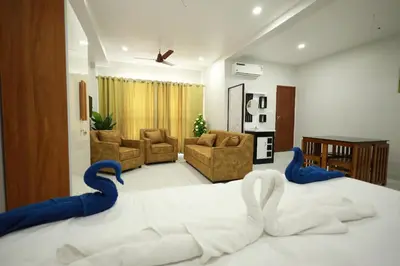 a bedroom with a large bed with blue snakes on it at Wayanad Palace in Ambalavayal