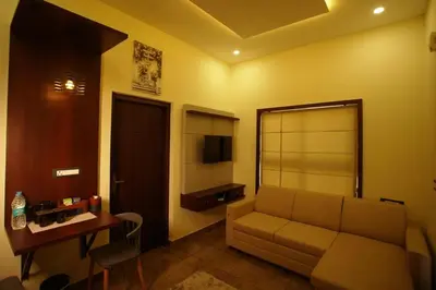 a living room with a couch and a table at Pabis luxurious stay in Vythiri